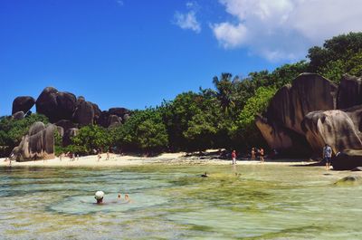 People at beach on island during summer