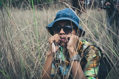 Portrait of man wearing sunglasses on field