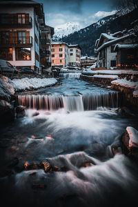 Water flowing over buildings during winter