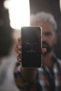 Close-up of man using mobile phone