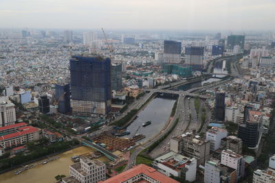 High angle view of illuminated city buildings against sky