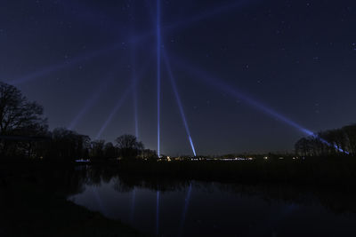 Scenic view of lake against sky at night