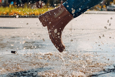 Low section of man splashing water