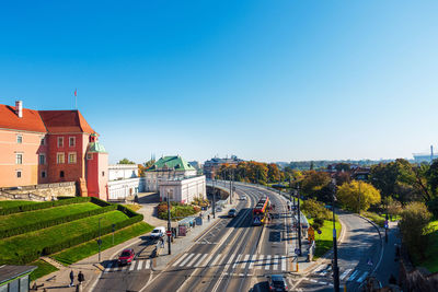 High angle view of city street against clear blue sky