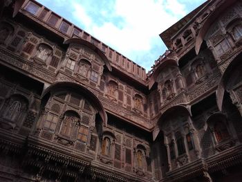 Low angle view of historic building against cloudy sky