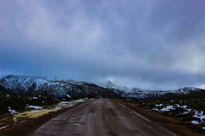 Empty road passing through mountains