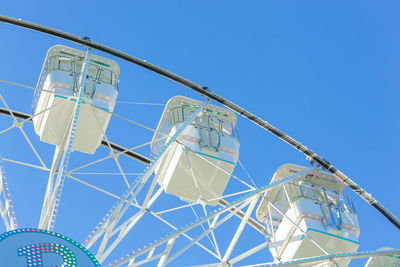 Low angle view of windmill against clear blue sky