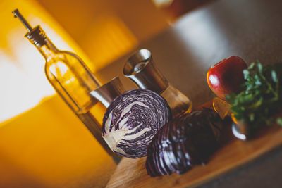 Close-up of vegetables and oil on table