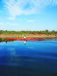 Person rowing boat in river