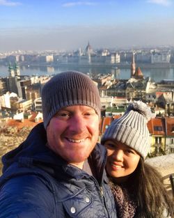 Portrait of smiling man and woman in city