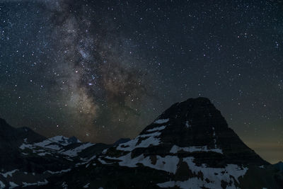 Scenic view of snowcapped mountain against sky during night