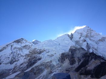 Scenic view of snowcapped mountains against clear blue sky