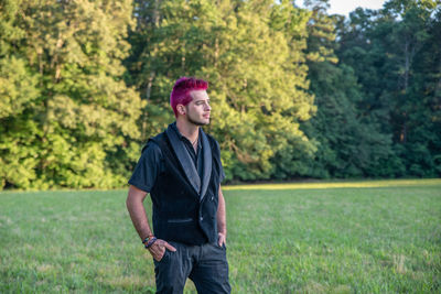 Man with pink hair standing outdoors