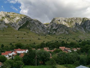 Scenic view of houses and mountains against sky