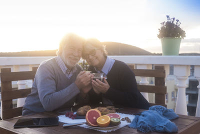 Portrait of senior couple having drink at cafe