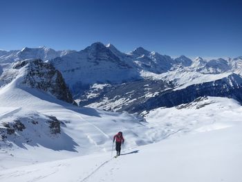 High angle view of person skiing on snowcapped mountain against clear sky