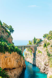 Arch bridge over sea against clear sky