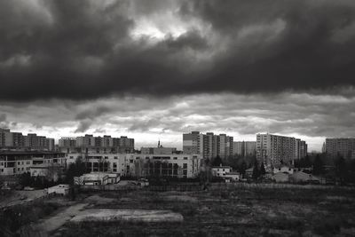 Buildings against cloudy sky