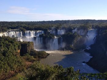 Scenic view of waterfall against sky