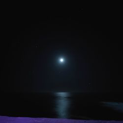 Scenic view of sea against sky at night