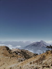 Scenic view of snowcapped mountains against blue sky