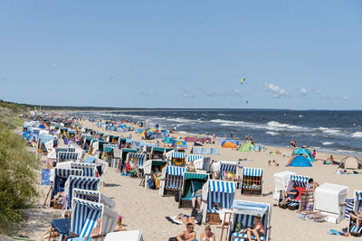 People at beach against sky