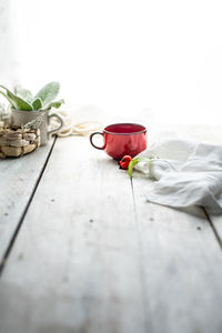 Close-up of red chili pepper on table against white background