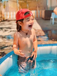 Full length of shirtless boy in swimming pool