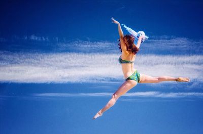 Full length of woman jumping in mid-air