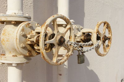 Close-up of rusty pipeline against wall