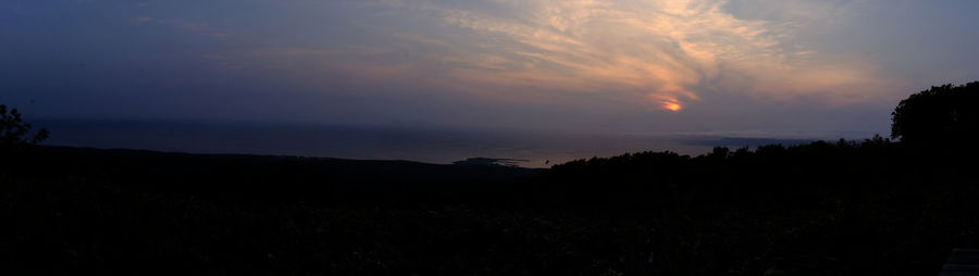 Scenic view of silhouette landscape against sky at sunset