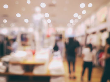 Defocused image of people at illuminated restaurant