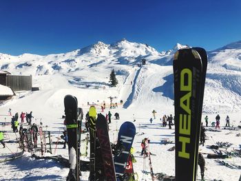 People on snow covered mountain against sky