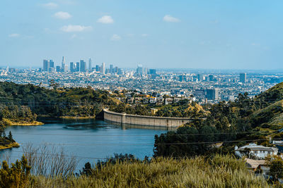 High angle view of river and buildings against sky