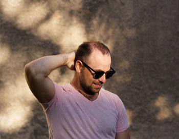 Portrait of young man wearing sunglasses standing outdoors