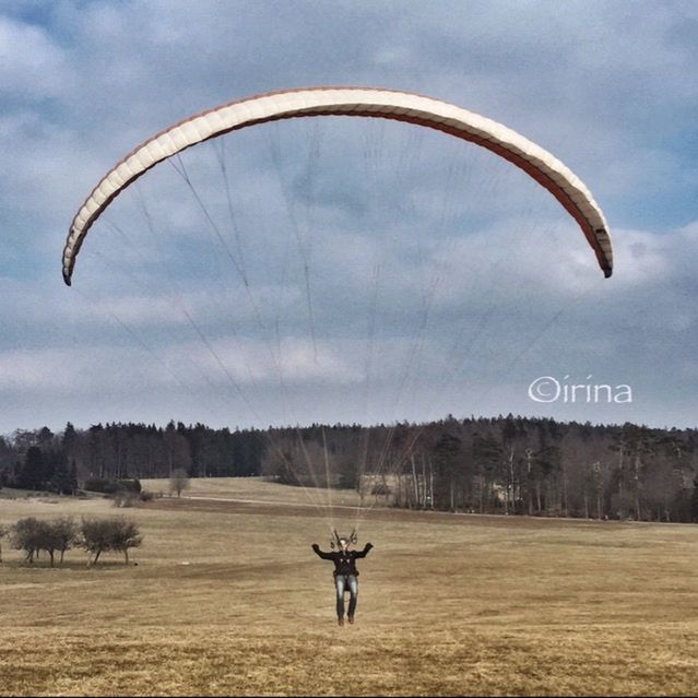 sky, sport, parachute, mid-air, cloud - sky, landscape, transportation, adventure, extreme sports, flying, tranquil scene, field, tranquility, leisure activity, cloud, nature, scenics, day