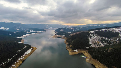 High angle view of river amidst mountains against sky