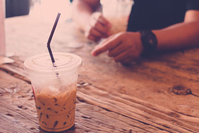 Iced cappuccino on wooden table.iced coffee in a plastic cup.