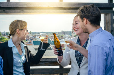 Happy friends toasting alcoholic drinks