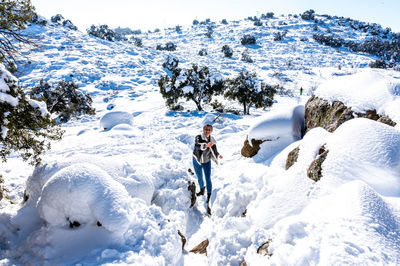 Man standing on snow covered snowcapped mountain