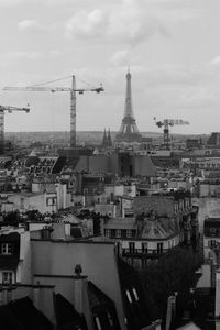 High angle view of buildings against cloudy sky