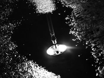 Low angle view of illuminated lights at night