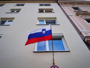 Low angle view of flag against building