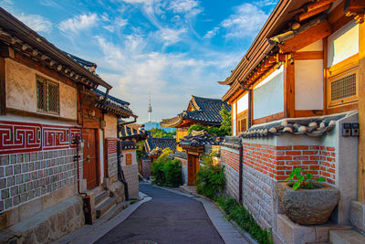 Street amidst buildings against sky