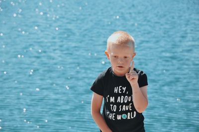 Full length of boy standing in sea