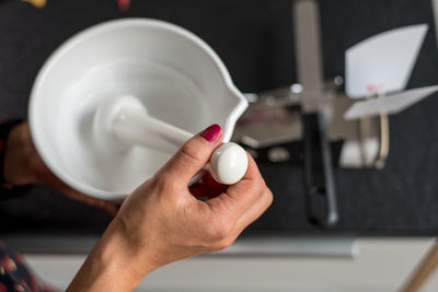 Cropped image of hand holding coffee cup