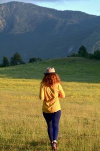 Rear view of woman on field