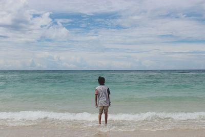 Rear view of man standing on beach