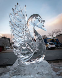 Close-up of frozen sculpture against sky