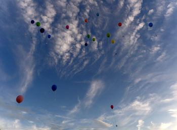 Low angle view of balloons against sky